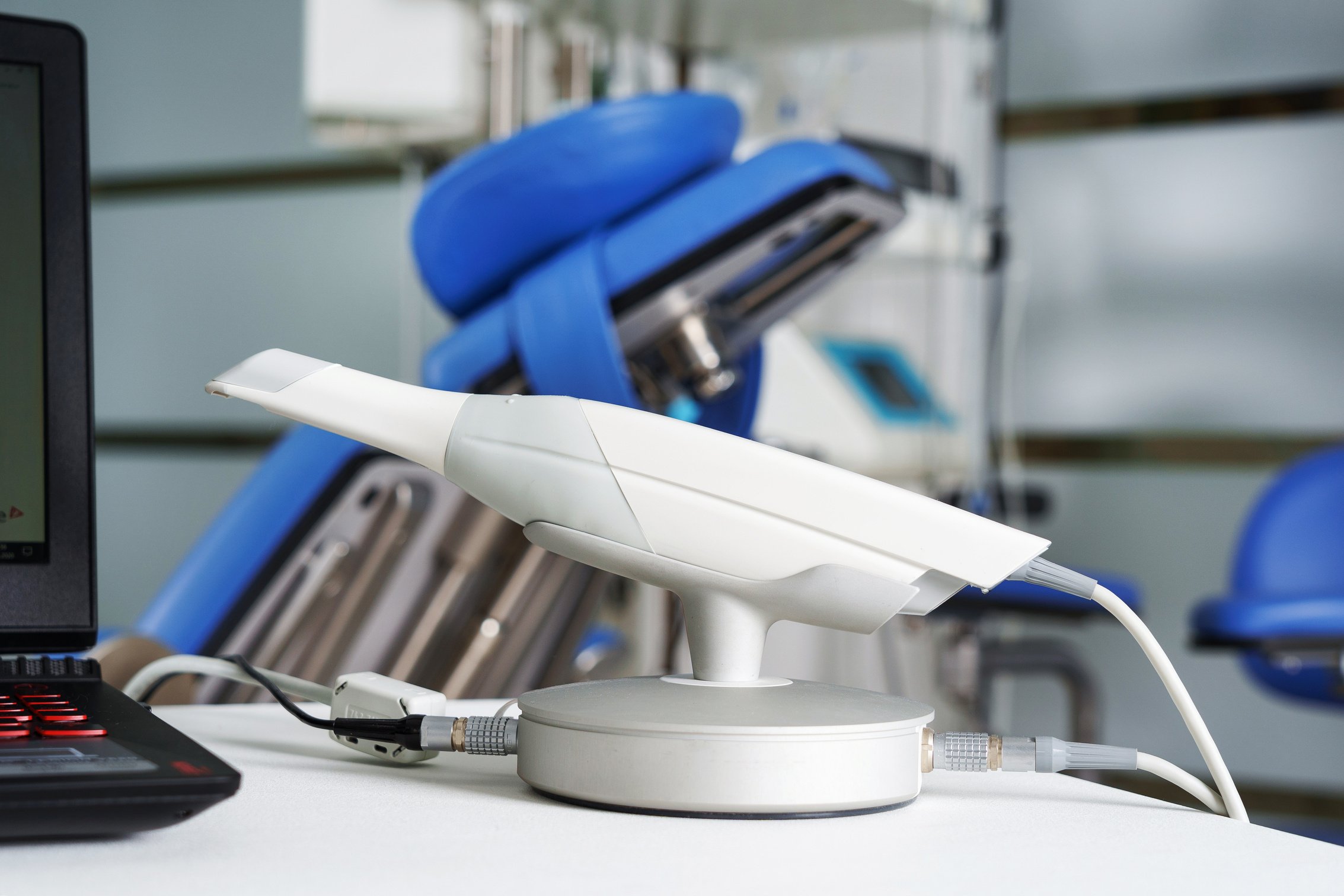 Modern Intraoral Dental Scanner Connected to a Laptop on the Bac